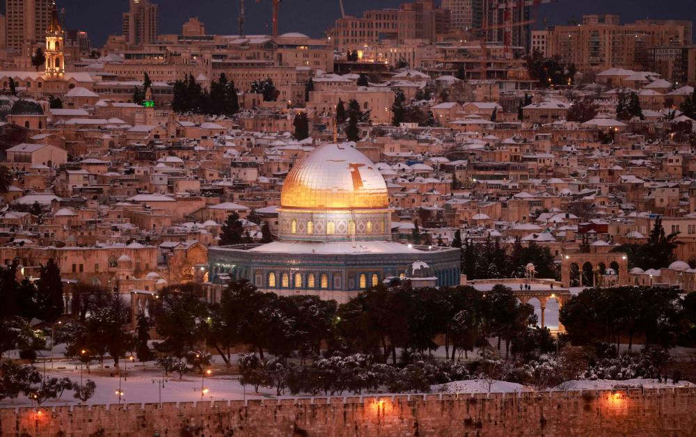 Snow covers the Dome of the Rock at the Al-Aqsa Mosque compound and the city of Jerusalem on January 27, 2022. AFPPIX