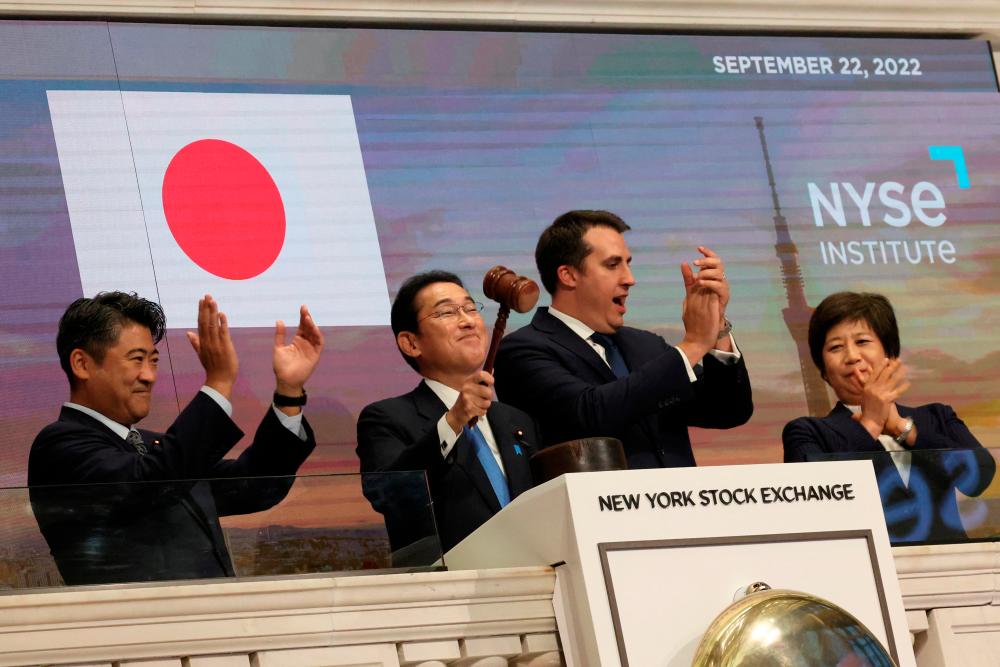 Japanese Prime Minister Fumio Kishida banging the gavel to signal the end of trading after ringing the closing bell at the New York Stock Exchange on Thursday, Sept 22. He said in a speech that excessive movement in the yen due to speculation cannot be overlooked and that his government will act ‘with a high level of vigilance’ and intervene to support the currency again if necessary. The Bank of Japan on Thursday bought yen to prop up the currency for the first time since 1998. – Reuterspix