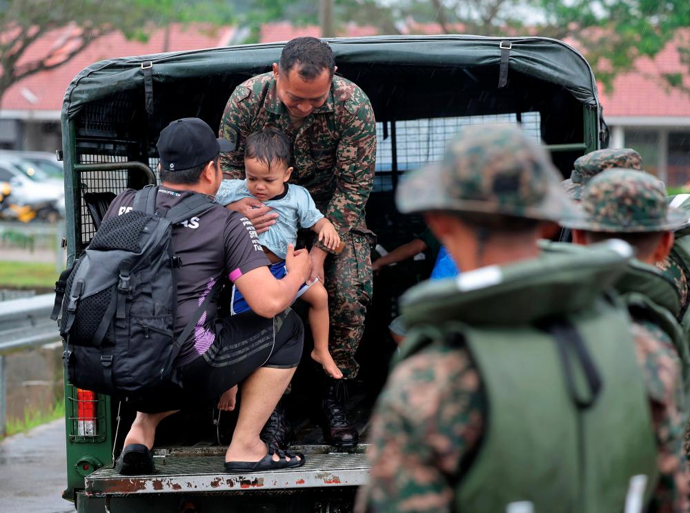 Anggota tentera membantu memindahkan mangsa banjir di Taman Desaru Utama, Bandar Penawar hari ini.fotoBERNAMA