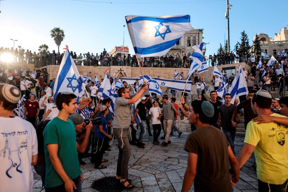 File photo: Israelis dance with flags by Damascus gate just outside Jerusalem's Old City June 15, 2021. REUTERSpix