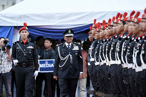 IGP Tan Sri Mohamad Fuzi Harun inspects police personnel during the officiating of the new Brickfields district police headquarters along Jalan Travers, on April 29, 2019. — Bernama