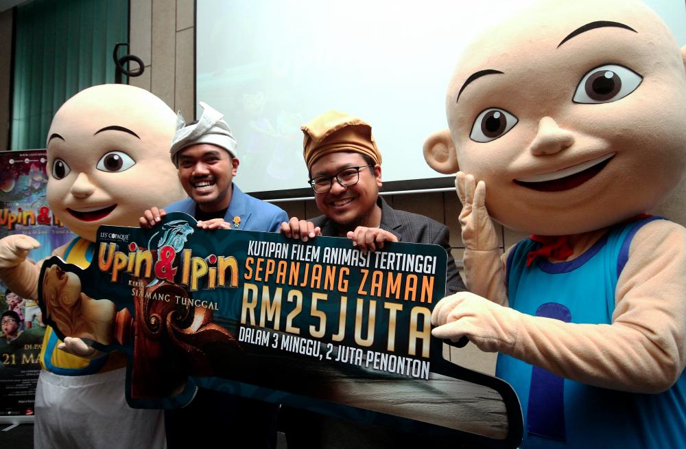 File photo taken on April 11 shows directors of Upin &amp; Ipin: Keris Siamang Tunggal, Adam Amiruddin (2R) and Ahmad Razuki Roseli (2L) posed alongside the Upin and Ipin mascots at a press conference. — Bernama