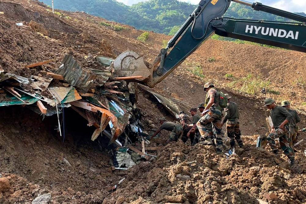 In this handout photo released by the Indian Army and taken on July 1, 2022, security forces and disaster relief teams search for survivors and victims after a landslide in Noney district, some 50 Km from Manipur's capital Imphal. INDIAN ARMY/AFPpix