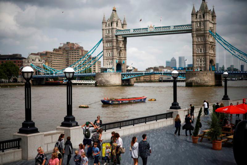 File photo: Tower Bridge can be seen as people walk along the River Thames, amid the coronavirus disease (Covid-19) pandemic in London, Britain, July 27, 2021. REUTERSpix
