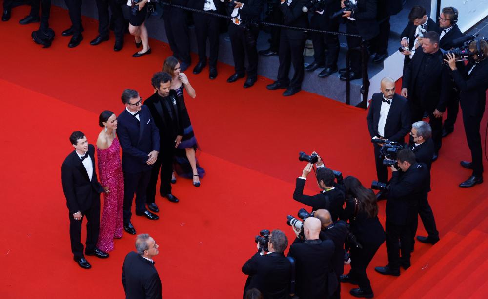 French zombie movie ‘Final Cut’ director Michel Hazanavicius and cast members pose on the Cannes red carpet. – Reuters