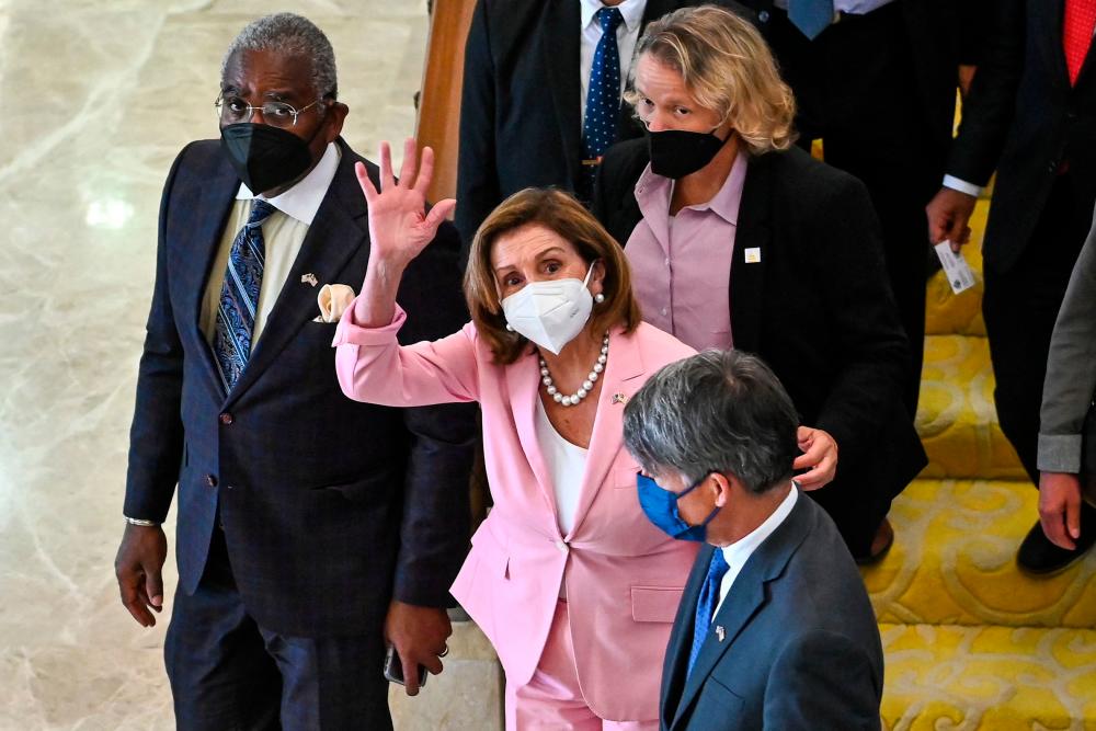 This handout photo taken and released by Malaysia's Department of Information on August 2, 2022, shows Speaker of the US House of Representatives Nancy Pelosi waving as she leaves the Parliament House after a meeting with Malaysian officials in Kuala Lumpur. AFPPIX