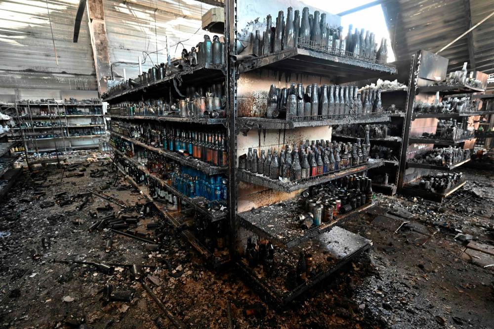 A photograph taken on June 28, 2022 shows charred goods in a grocery store of the destroyed Amstor mall in Kremenchuk. – AFPPIX