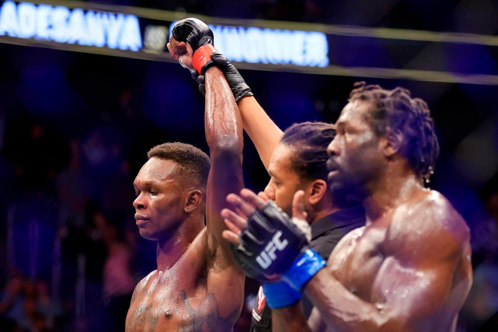 LAS VEGAS, NEVADA - JULY 02: Israel Adesanya (L) of Nigeria celebrates his unanimous decision win over Jared Cannonier in their middleweight title bout during UFC 276 at T-Mobile Arena on July 02, 2022 in Las Vegas, Nevada. AFPPIX