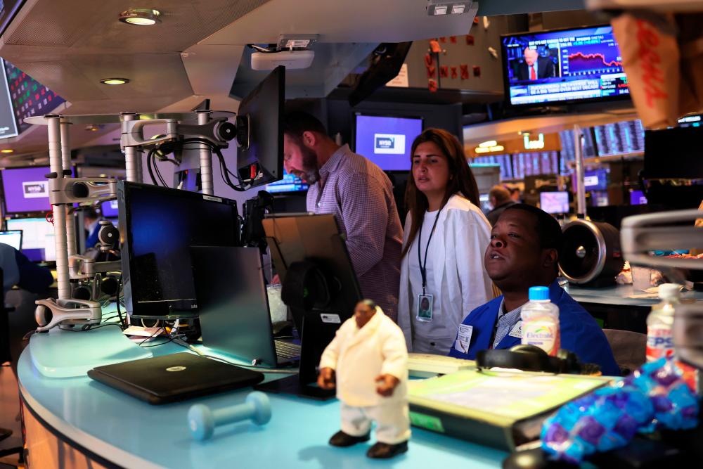 Traders working on the floor of the New York Stock Exchange yesterday. AFPpix