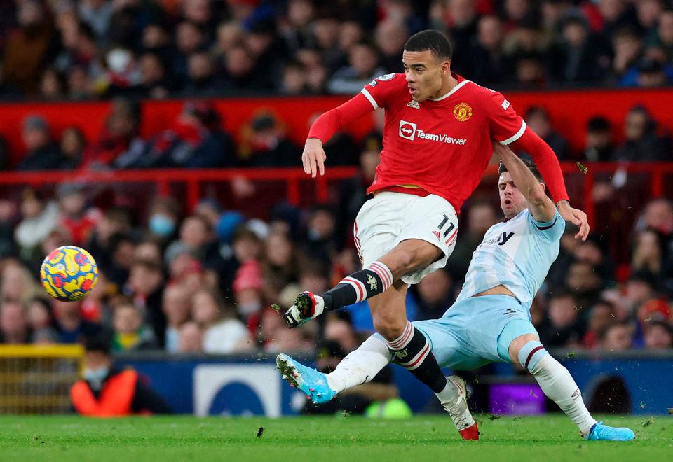 Soccer Football - Premier League - Manchester United v West Ham United - Old Trafford, Manchester, Britain - January 22, 2022, Manchester United’s Mason Greenwood in action with West Ham United’s Aaron Cresswell. REUTERSPix