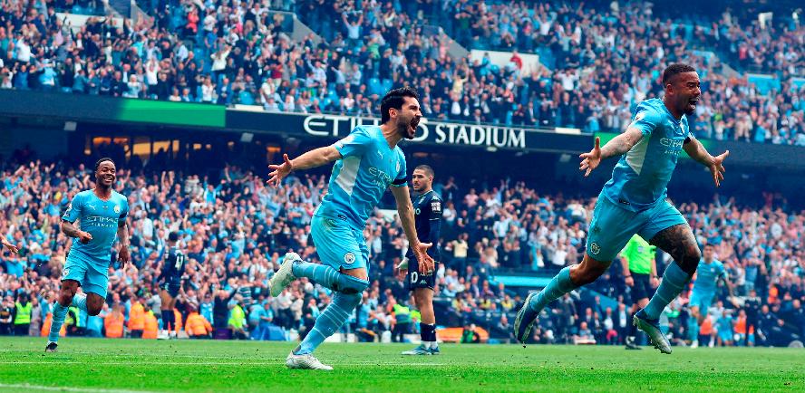 Manchester City’s Ilkay Gundogan (centre) celebrates scoring their third goal with Gabriel Jesus (right) during the English Premier League match against Aston Villa at the Etihad stadium on May 22, 2022. – REUTERSPIX