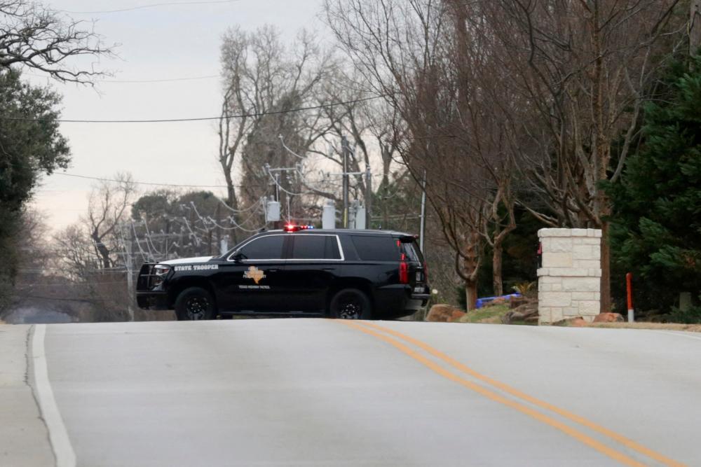 A law enforcement vehicle blocks the street where a man has reportedly taken people hostage at a synagogue during services that were being streamed live, in Colleyville, Texas, U.S. January 15, 2022. REUTERSpix