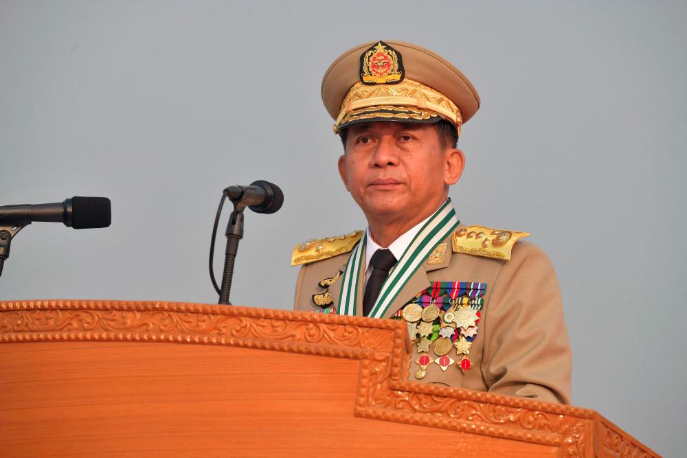 This handout photo taken and released on March 27, 2022 by the Myanmar Military Information Team shows Chief Senior General Min Aung Hlaing attending a ceremony to mark the country's 77th Armed Forces Day in Naypyidaw. -AFPPIX