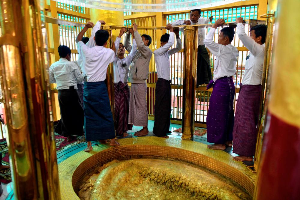 This picture taken on January 25, 2023 shows members of trustees preparing to open the footprint of buddha during the Mann Shwe Sat Thaw Pagoda Festival at Min Bu township in Magway Region. AFPPIX