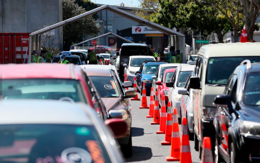 Members of the public wait in cars at a drive-through coronavirus disease (Covid-19) vaccination clinic during a single-day vaccination drive, aimed at significantly increasing the percentage of vaccinated people in the country, in Auckland, New Zealand, October 16, 2021. REUTERSpix