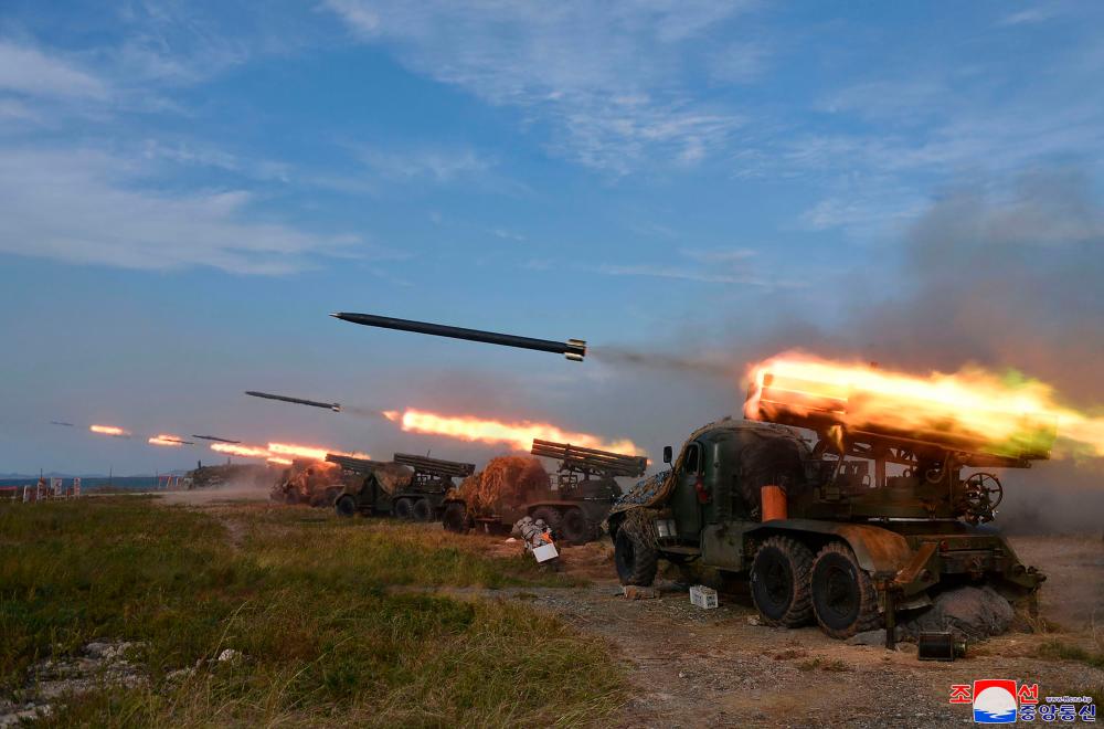This picture taken on October 6, 2022 and released from North Korea's official Korean Central News Agency (KCNA) on October 10, 2022 shows the North Korean People's Army front-line long-range artillery division and air force squadron during a fire attack training exercise, at an undisclosed location. AFPPIX