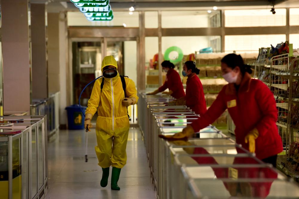 In this file photo taken on March 18, 2022 employees spray disinfectant and wipe surfaces as part of preventative measures against the Covid-19 coronavirus at the Pyongyang Children's Department Store in Pyongyan. AFPpix