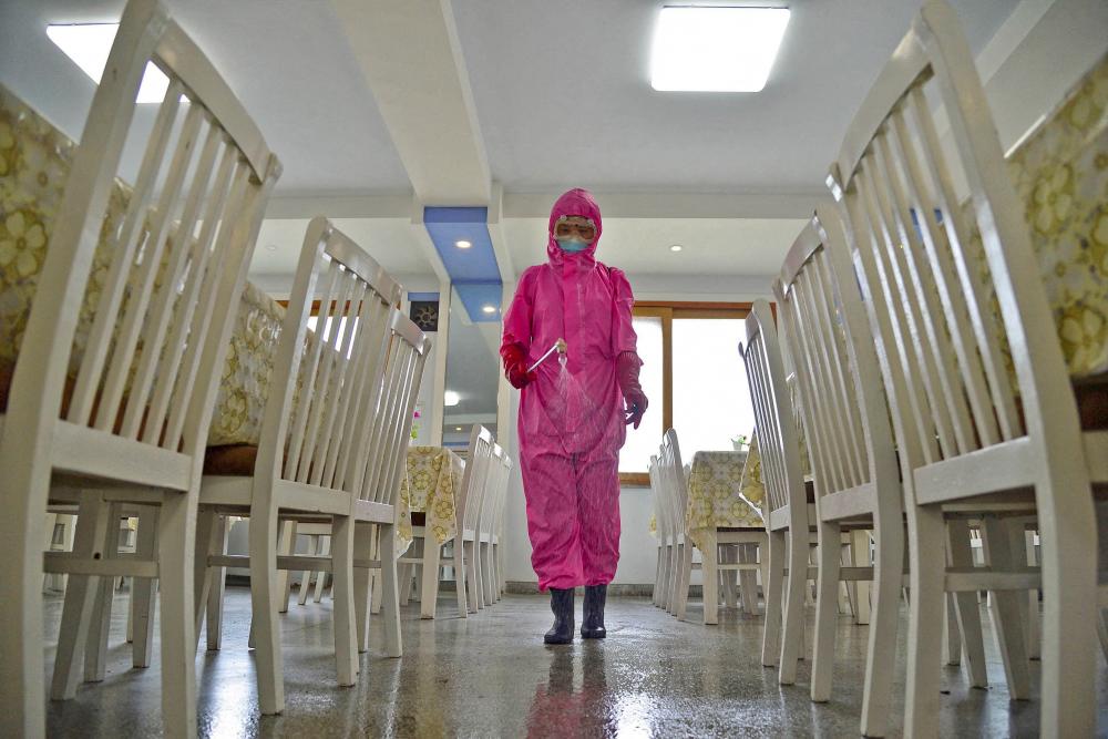 A worker disinfects a dining room at a sanitary supplies factory, amid growing fears over the spread of the coronavirus disease (Covid-19), in Pyongyang, North Korea, in this photo taken on May 16, 2022 and released by Kyodo on May 17, 2022. Kyodo/via REUTERSpix
