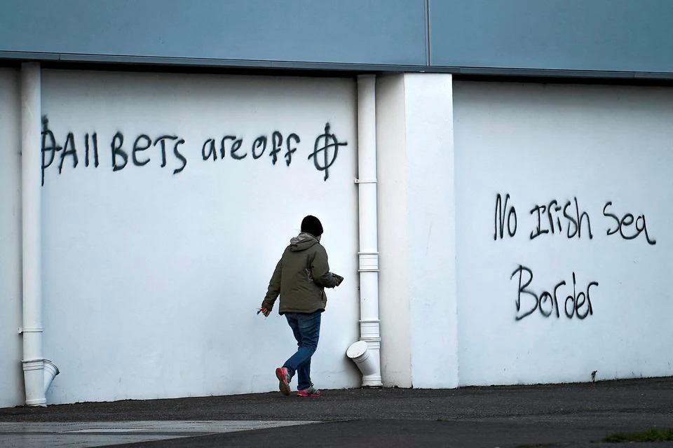 File photo: Loyalist graffiti is seen with messages against the Brexit border checks in relation to the Northern Ireland protocol at the harbour in Larne, Northern Ireland February 12, 2021. REUTERSpix