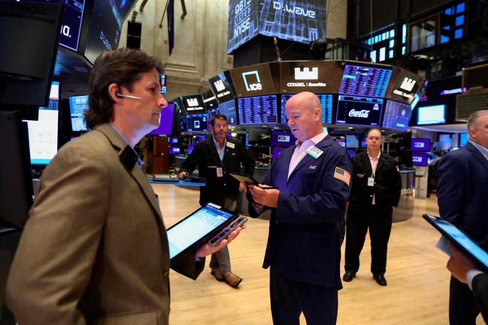 Traders on the floor of the New York Stock Exchange. – Reuterspix