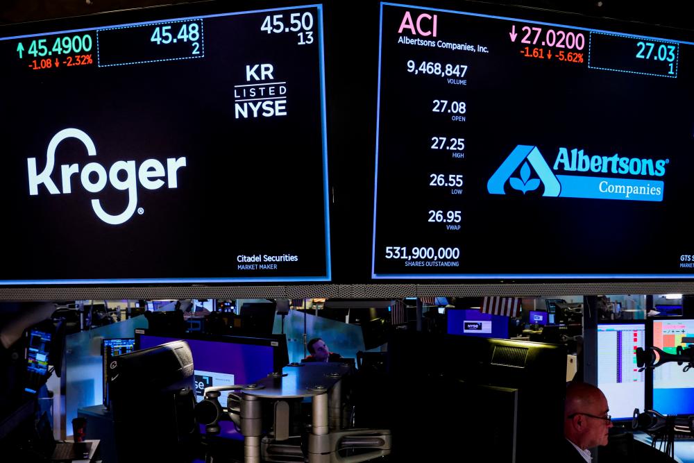 Traders at work as screens display trading information on the floor of the New York Stock Exchange on Oct 14, 2022. – Reuterspic