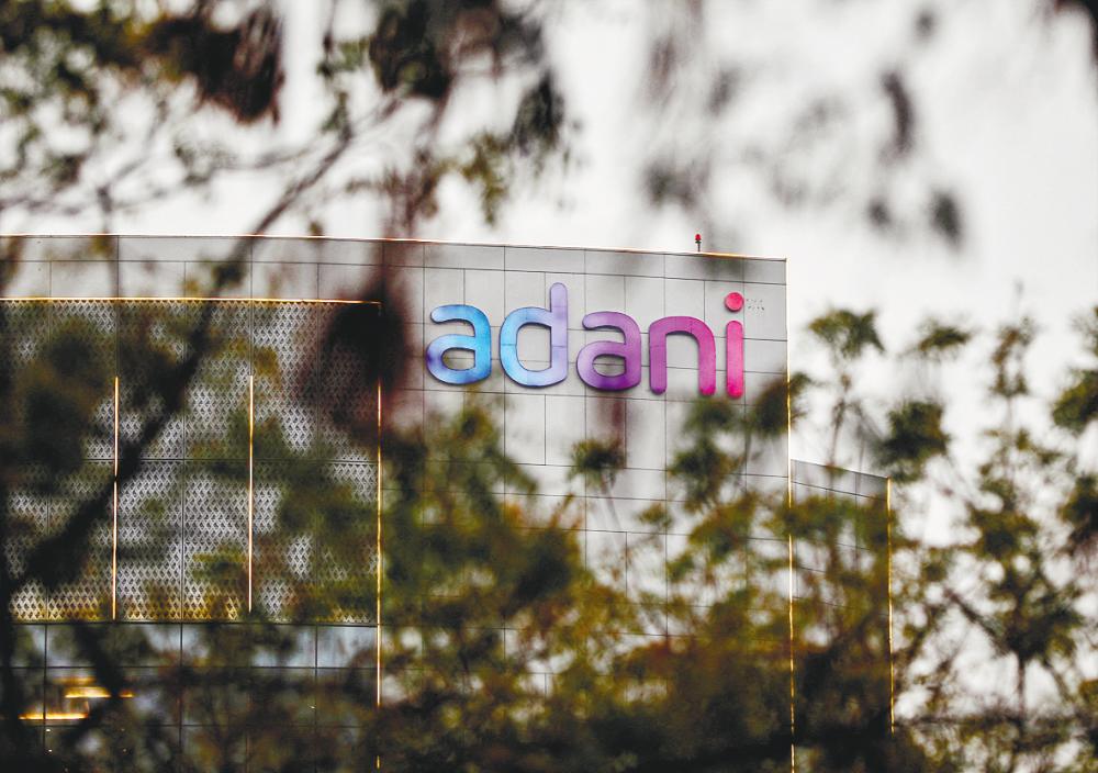 The logo of the Adani Group is seen on the facade of its Corporate House on the outskirts of Ahmedabad, India. – Reuterspic