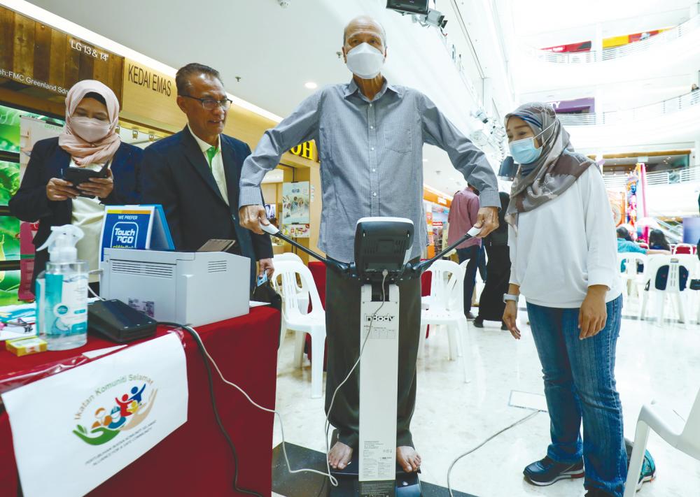 Lee using a device to measure his Body Mass Index during the event. – HAFIZ SOHAIMI/THESUN