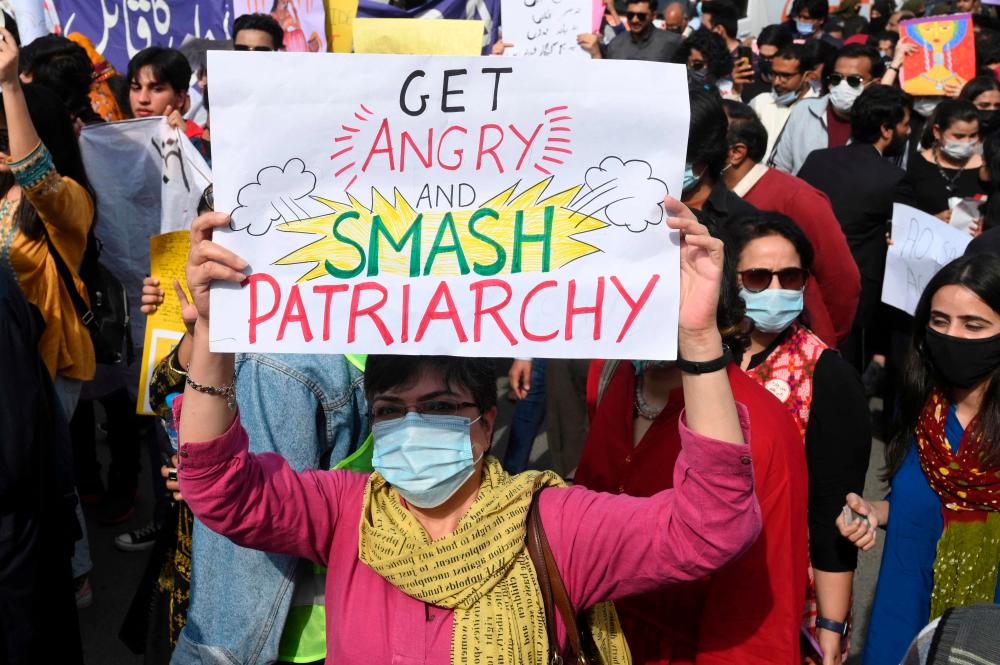 Aurat March activists hold placards during a demonstration to mark the International Women’s Day in Lahore on March 8, 2022. AFPPIX