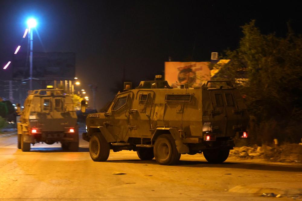 Israeli forces armoured vehicles storm the Aqabet Jaber refugee camp near Jericho in the occupied West Bank in the early hours of May 25, 2023. AFPPIX