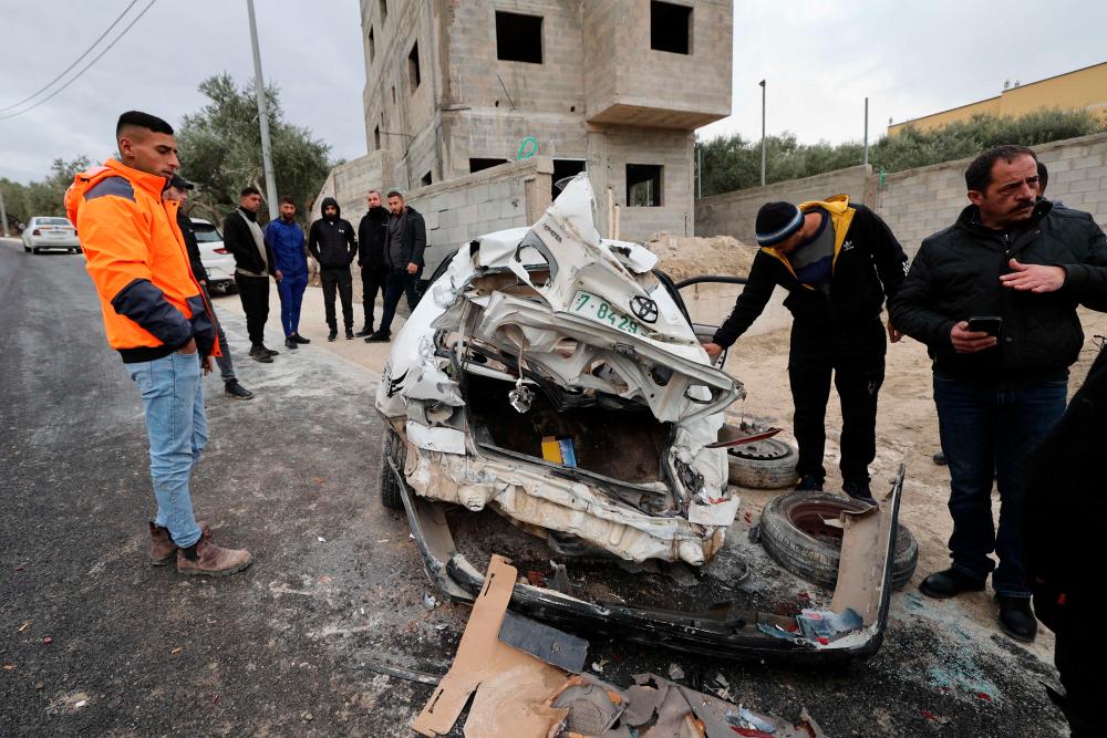 Onlookers surround a bullet-riddled car in which 2 Palestinians were reportedly killed by Israeli troops in Jaba near the West Bank town of Jenin, on January 14, 2023. AFPPIX