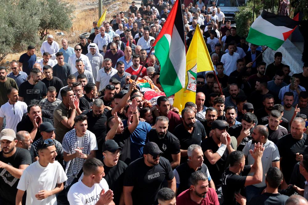 Palestinian mourners carry the body of seven-year-old Palestinian, Rayan Suleiman, who died the day before in unclear circumstances in the village of Tuqu, during his funeral in the village, south of Bethlehem in the occupied West Bank, on September 30, 2022. AFPPIX