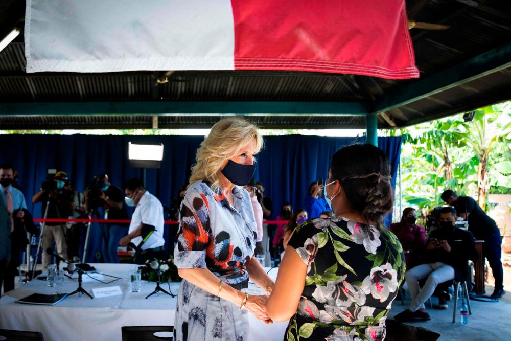 US First Lady Jill Biden talks with a woman at Casa Hogar El Buen Samaritano, “The Good Samaritan Home”, a shelter that houses people living with HIV/AIDS and assists with their care in Panama City, Panama, on May 21, 2022. AFPPIX