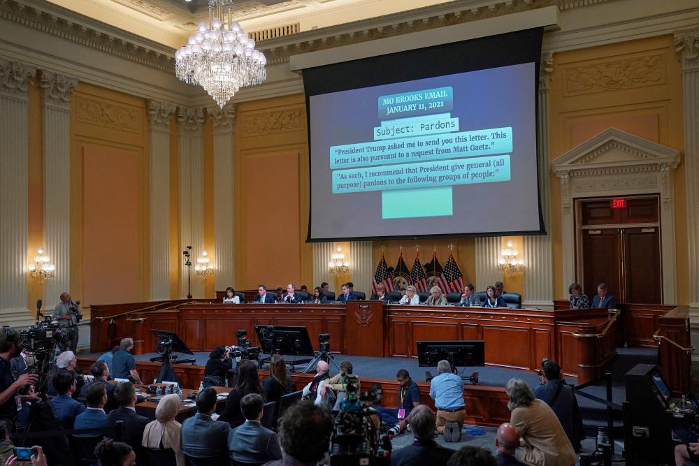 An email from U.S. Rep. Mo Brooks (R-AL), regarding a potential pardon for Rep. Matt Gaetz (R-FL) is shown on a screen, as the U.S. House Select Committee to Investigate the January 6 Attack on the United States Capitol, holds the hearing on Capitol Hill in Washington, U.S., June 23, 2022. Demetrius Freeman/Pool via REUTERSpix
