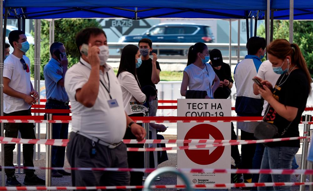 People queue in front of the coronavirus disease testing facility in Almaty, Kazakhstan July 8, 2020. - Reuters