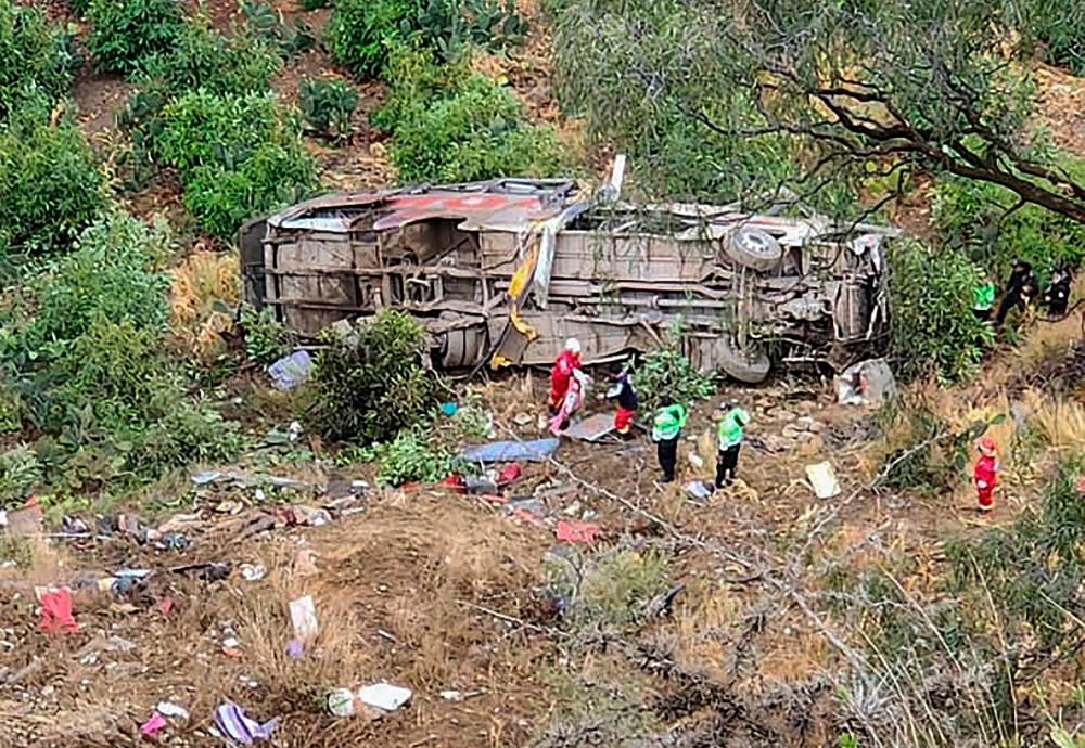 Picture released by the Municipality of Anco showing rescue teams working at the site where a bus plunged into a ravine in a remote rural mountain road in southeastern Peru, on September 18, 2023, leaving at least 24 dead. AFPPIX