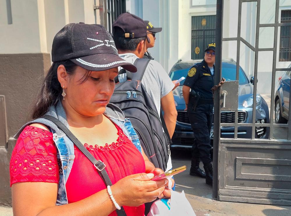 Relatives of arrested protesters during the raid conducted at a university campus the day before gather outside a police dependency to inquire for information about their whereabouts in Lima on January 22, 2023. AFPPIX