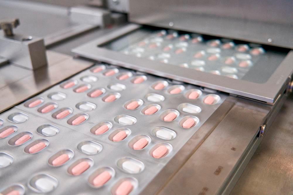 (FILES) This handout file photo provided on November 16, 2021, courtesy of Pfizer, shows the making of its experimental Covid-19 antiviral pills, Paxlovid, in Freiburg, Germany. AFPPIX