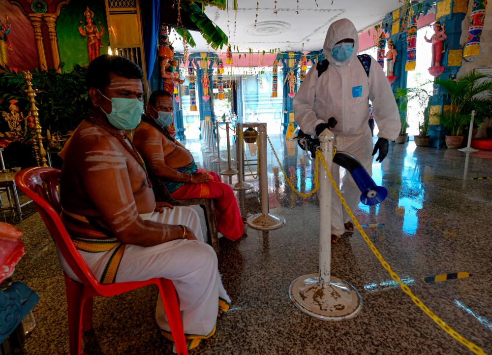 IPOH, Jan 17-Cleaning officer, S. Rajalingam 58, (right) conducts sanitation work around the temple area to comply with standard operating procedures (SOP) set by the government to curb the spread of COVID-19 ahead of the Thaipusam festival tomorrow during a survey. BERNAMApix