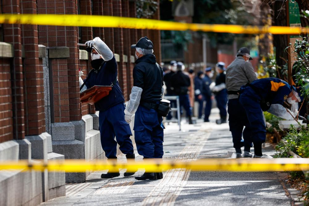 Police officers inspect an area at Tokyo University after a stabbing incident, in Tokyo/REUTERSPix