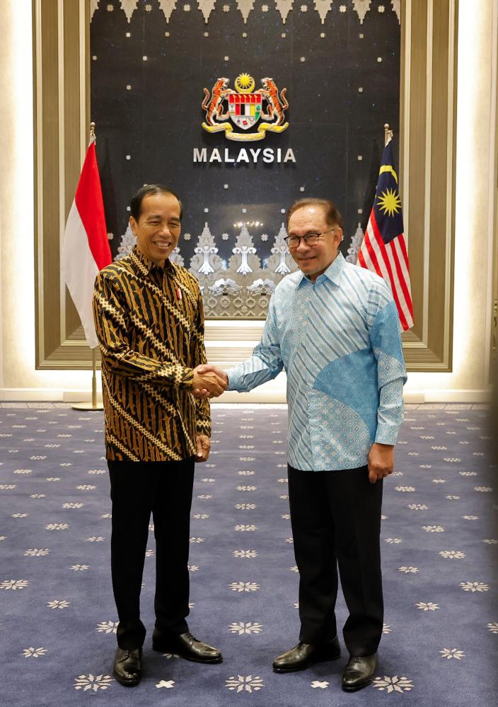 Prime Minister Datuk Seri Anwar Ibrahim welcomes Indonesian President Joko Widodo, who is on a two-day working visit to Malaysia, at Seri Perdana, Putrajaya on June 8 2023. - fotoBERNAMA