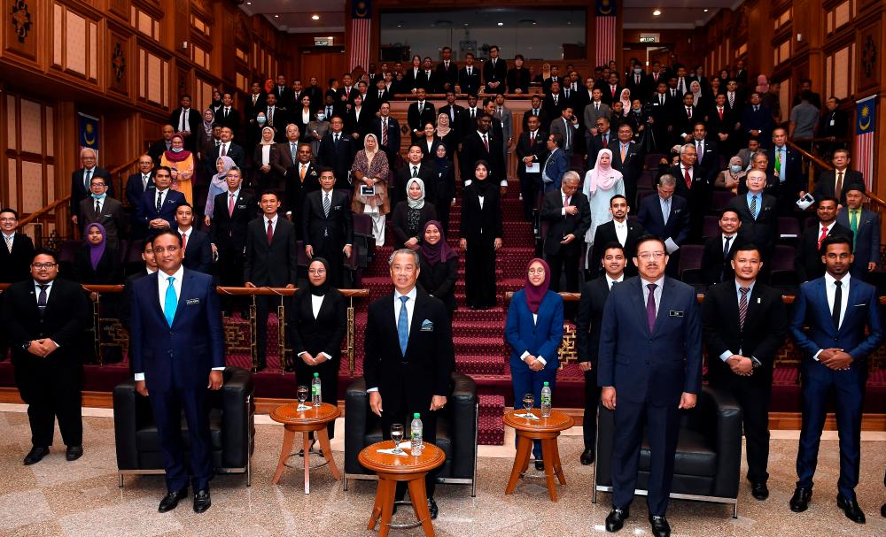 Prime Minister Tan Sri Muhyiddin Yassin (middle) at the presentation of this year's Perdana Fellows to the cabinet at Perdana Putra today. - Bernama