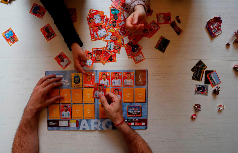 Lucas Perrone, 39, pastes soccer World Cup stickers with his kids in Buenos Aires, Argentina September 16, 2022. REUTERSPIX