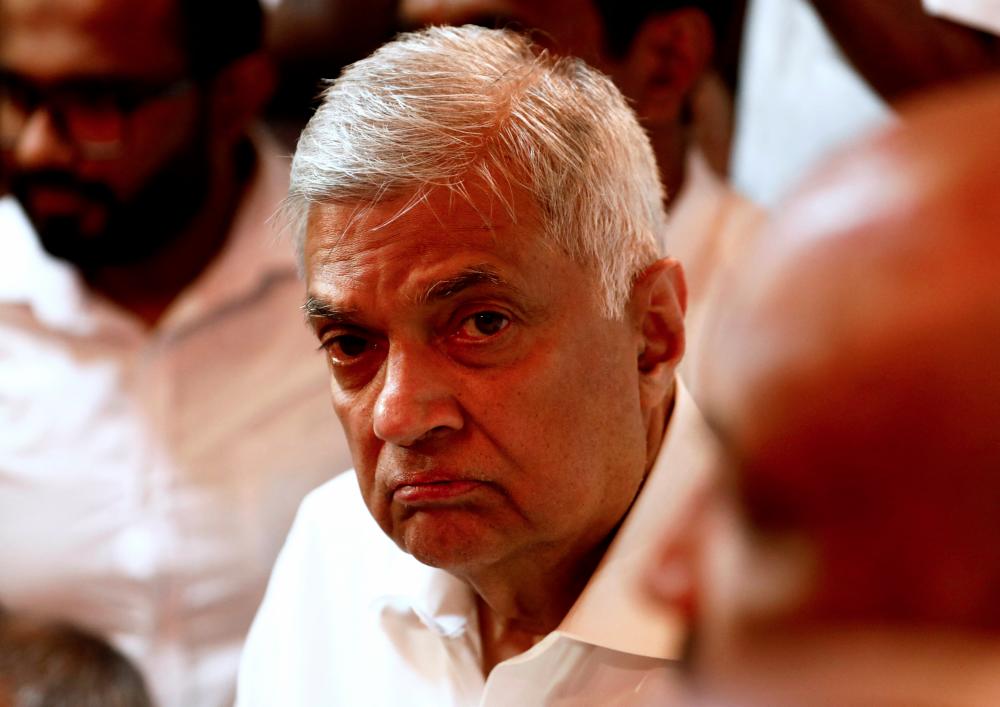 Ranil Wickremesinghe, newly appointed prime minister, arrives at a Buddhist temple after his swearing-in ceremony, amid the country's economic crisis, in Colombo, Sri Lanka, May 12, 2022. REUTERSpix