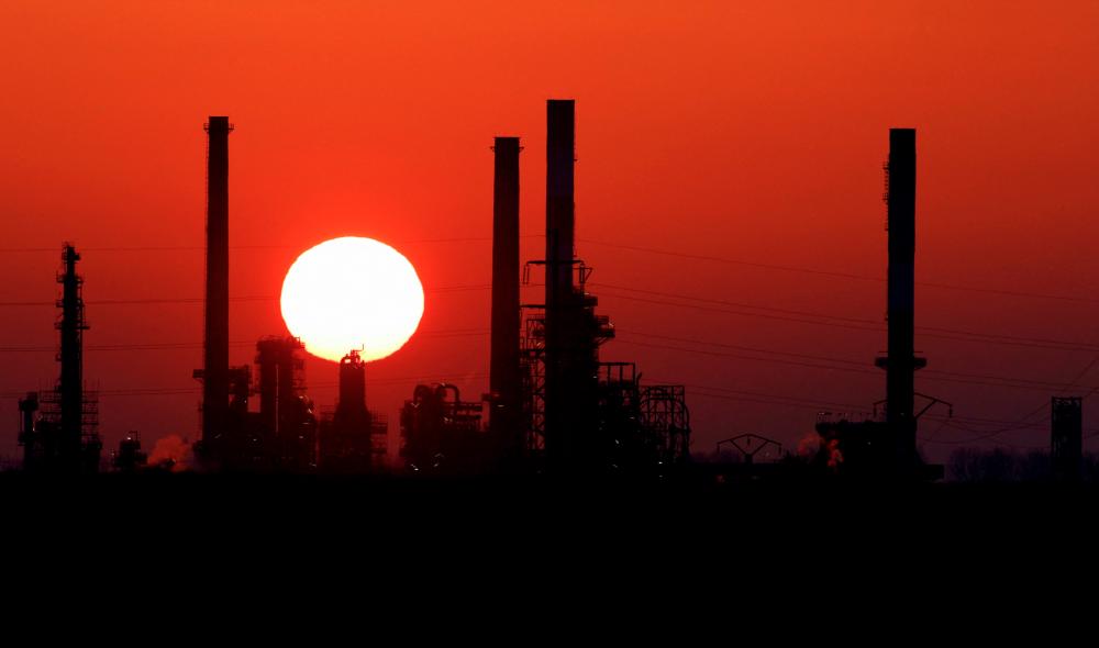 The sun sets behind the chimneys of an oil refinery in the southeast of Paris, France. – Reuterspix