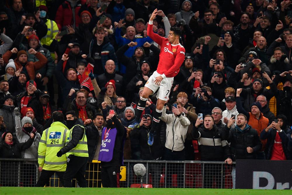 Manchester United's Portuguese striker Cristiano Ronaldo celebrates after scoring their third goal from the penalty spot during the English Premier League football match between Manchester United and Arsenal at Old Trafford in Manchester, north west England, on December 2, 2021. AFPpix