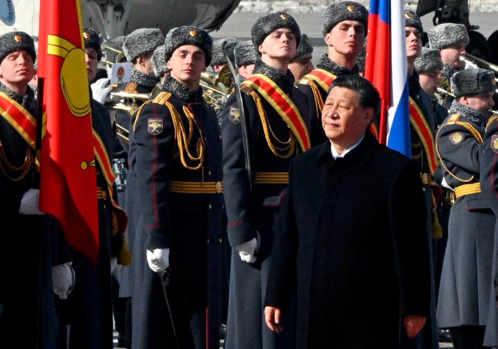 China’s President Xi Jinping walks past honour guards during a welcoming ceremony at Moscow’s Vnukovo airport on March 20, 2023. AFPPIX