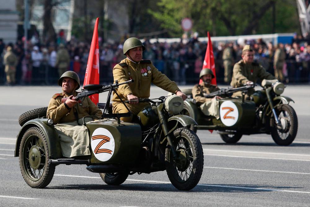 File pix: Participants wearing historical uniforms ride in WWII-era motorcycles adorned with stickers of the letter Z, which has become a symbol of support for Russian military action in Ukraine, during a military parade, which marks the 77th anniversary of the Soviet victory over Nazi Germany in World War Two, in Novosibirsk on May 9, 2022. AFPPIX