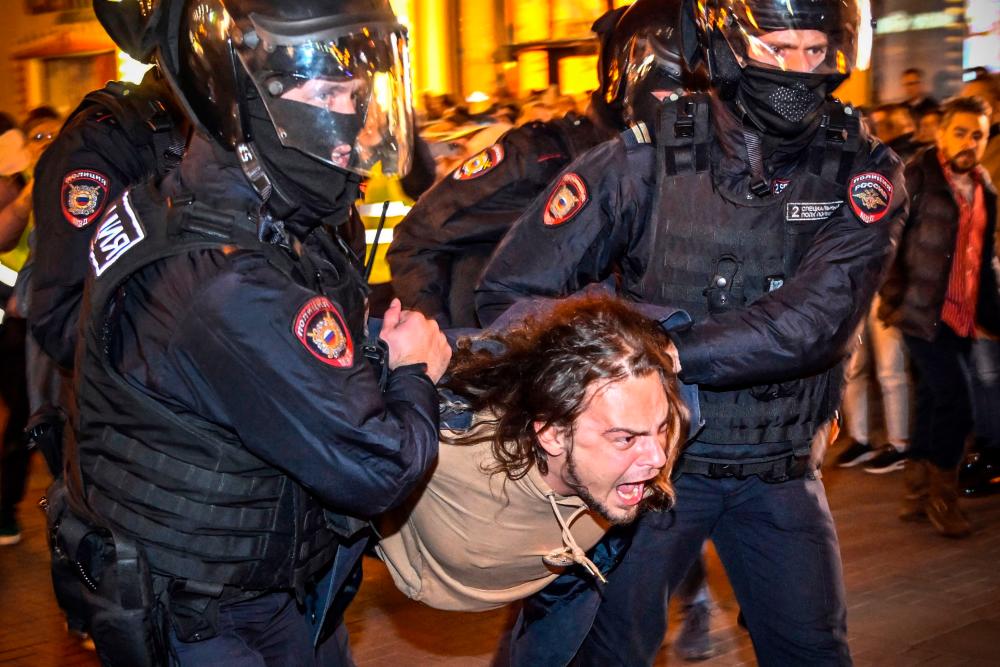 Police officers detain a man following calls to protest against partial mobilisation announced by Russian President, in Moscow, on September 21, 2022. AFPPIX