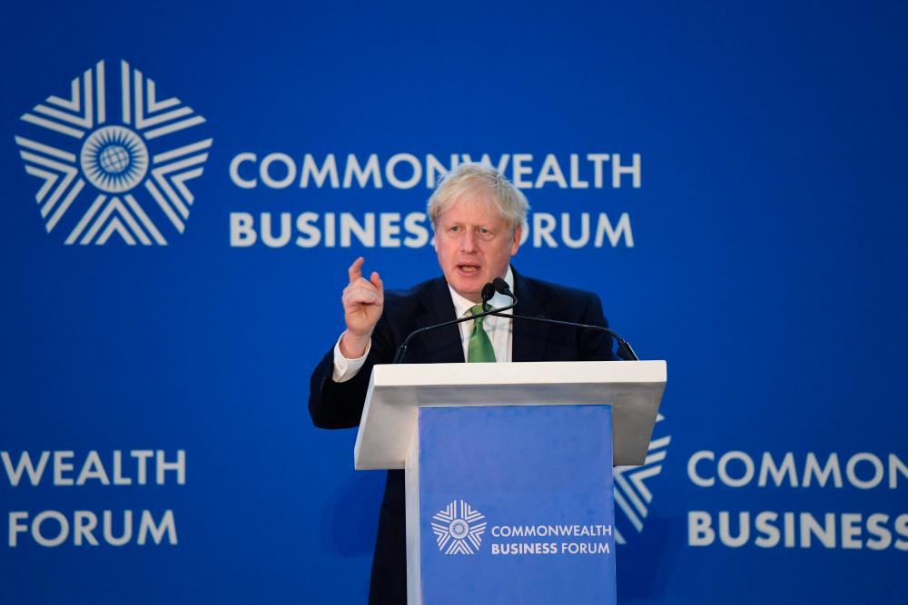 Britain’s Prime Minister Boris Johnson addresses a conference on “Achieving a greener future” in Kigali, Rwanda, on June 23, 2022 during the Commonwealth Heads of Government Meeting (CHOGM). AFPPIX