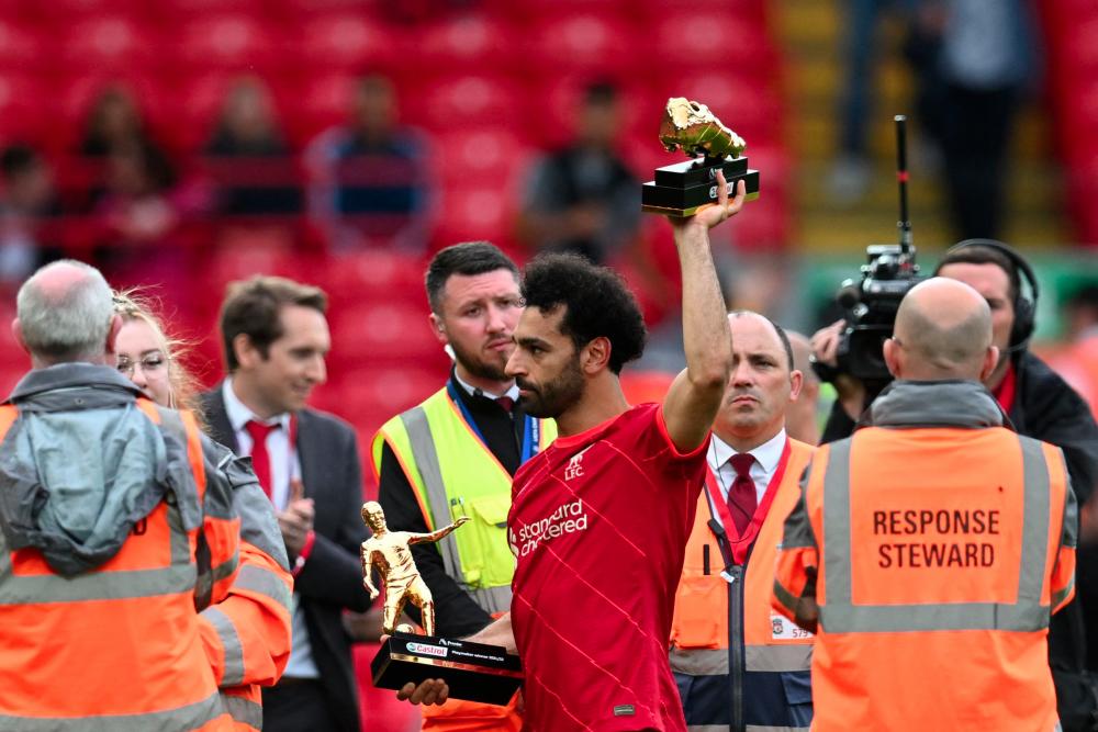 Liverpool's Egyptian midfielder Mohamed Salah celebrates with his two trophies golden boot and playmaker of the year at the end of the English Premier League football match between Liverpool and Wolverhampton Wanderers at Anfield in Liverpool, north west England on May 22, 2022. AFPpix
